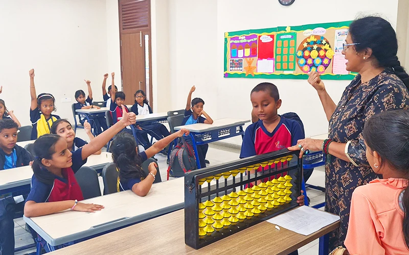 Students learning with a large classroom abacus